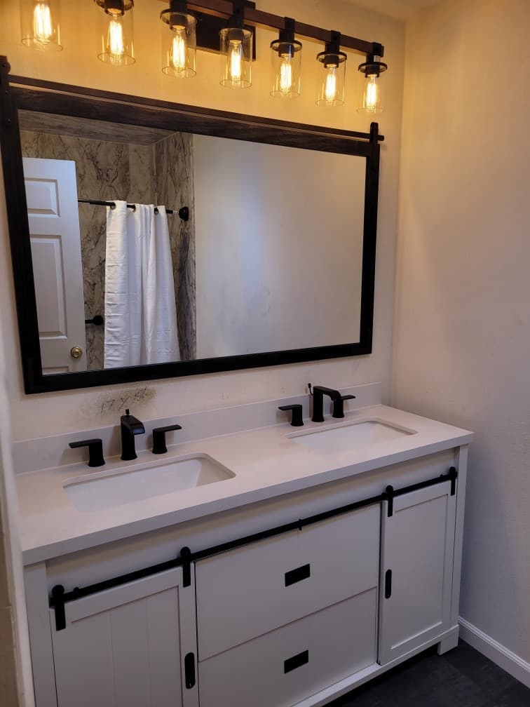 New farmhouse-style double vanity with Edison lighting