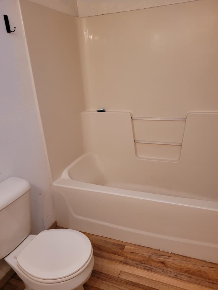 Theresa's bathroom before the remodel with peeling flooring