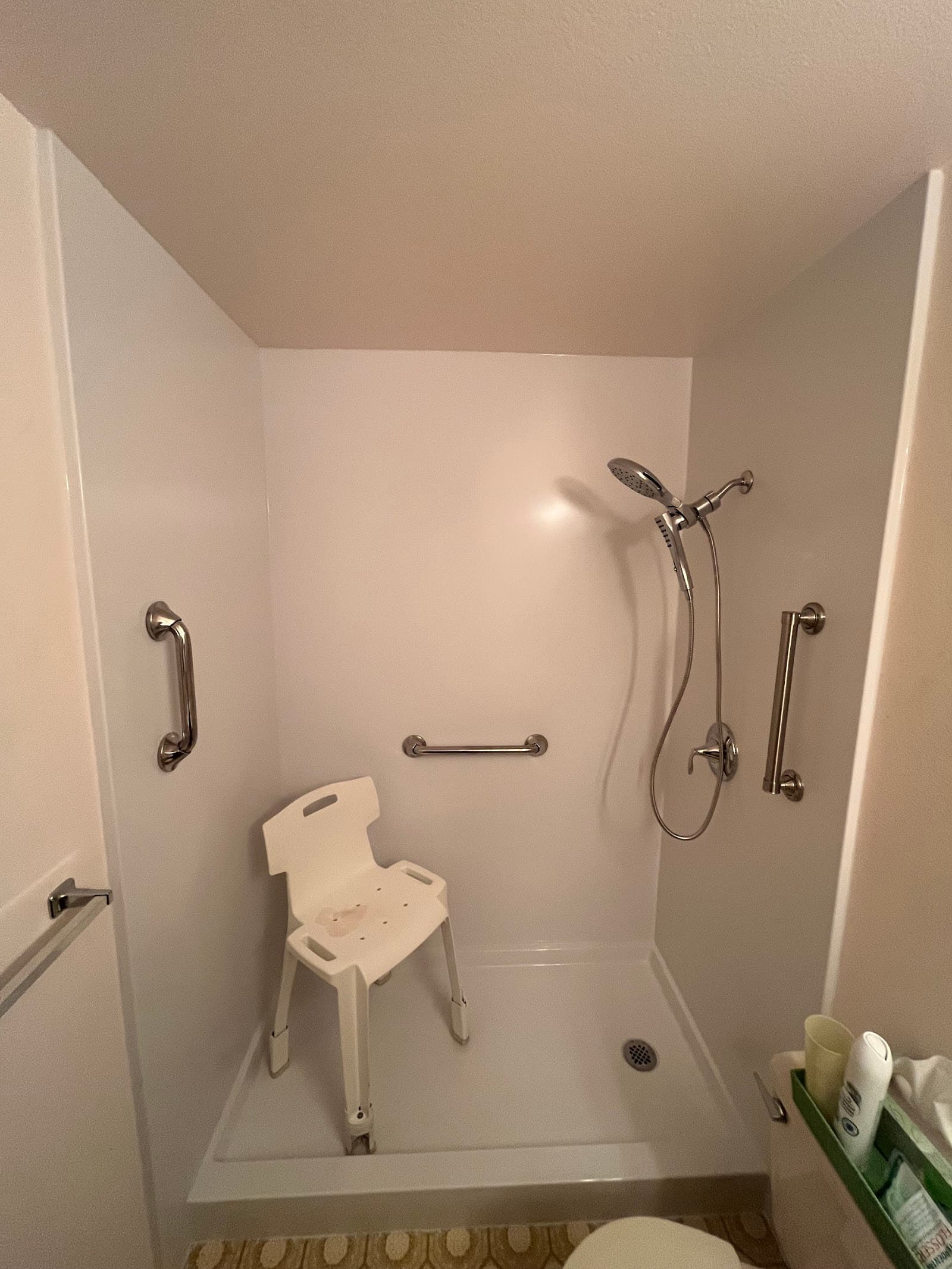 Walk-in shower with fold-down seat and grab bars installed by KVB