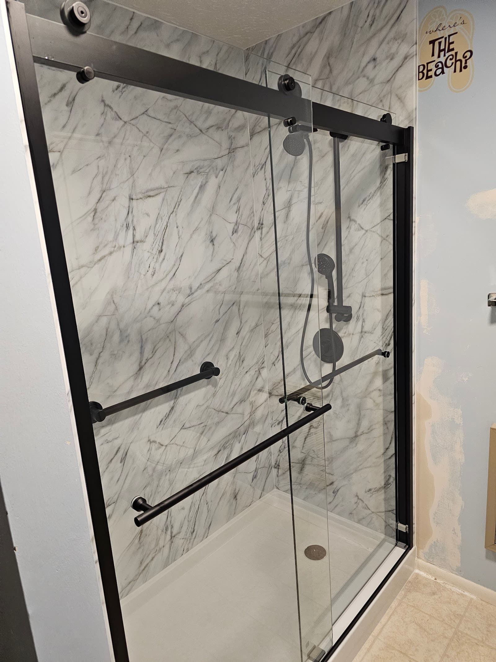 Marble-look shower with matte black fixtures, installed in Boise